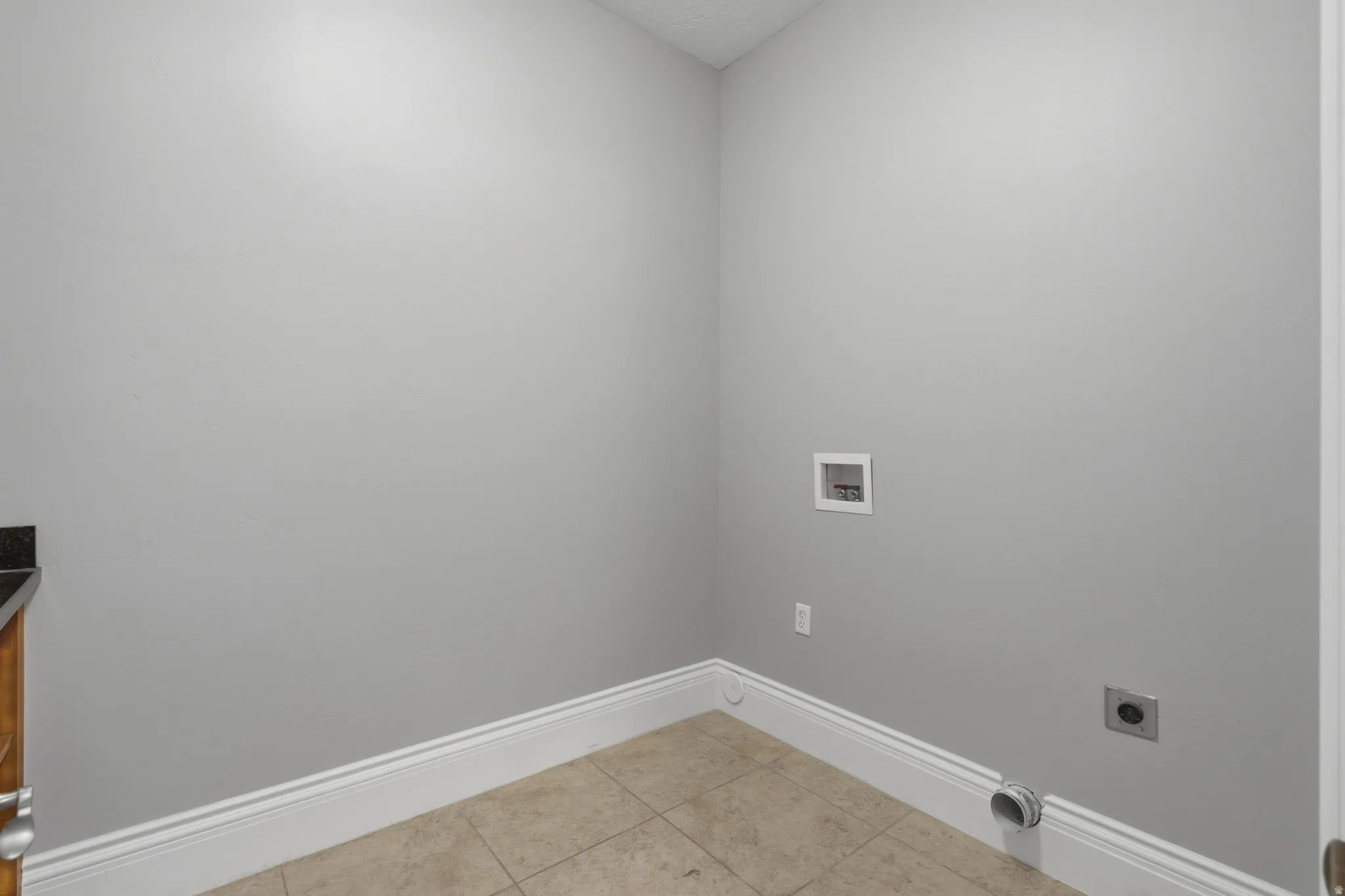 Tiled flooring, light gray wall paint, and white trim