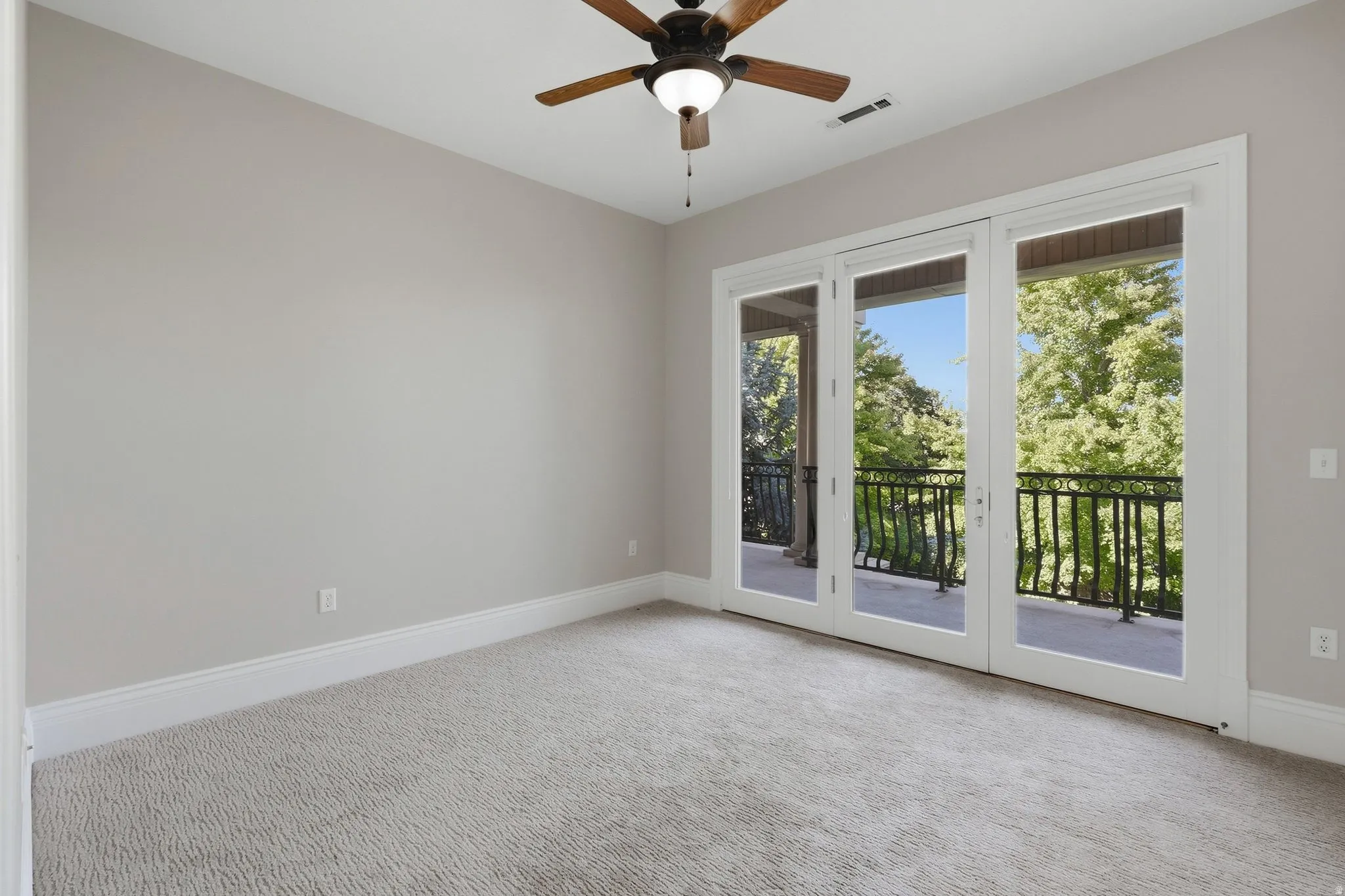 Light gray wall paint, white trim, recessed lighting, and a ceiling fan with integrated lighting
