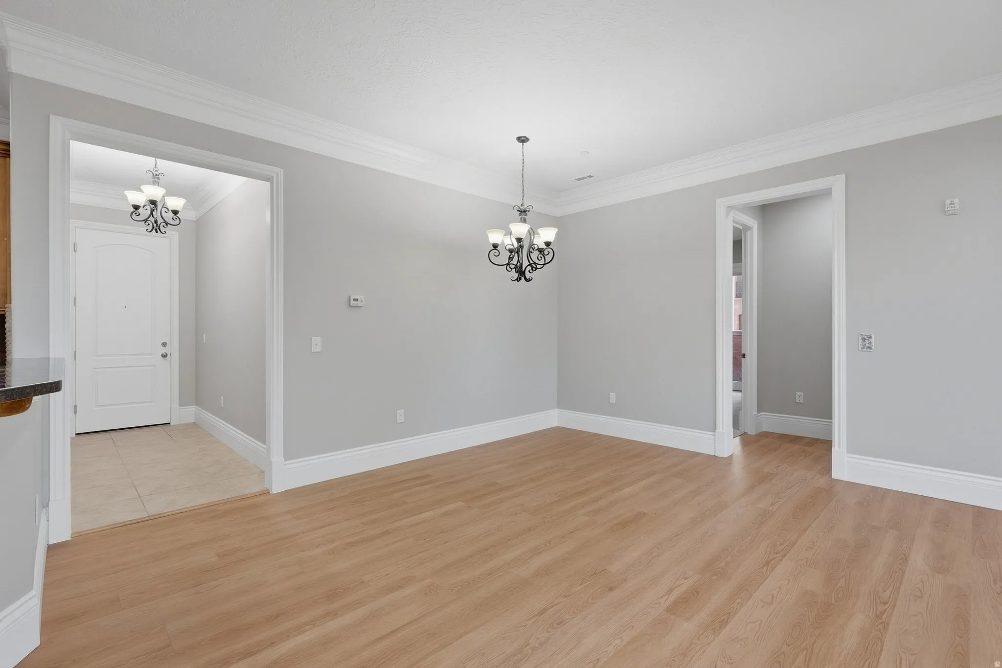 Wood-finish flooring throughout, complemented by crown molding and white baseboards