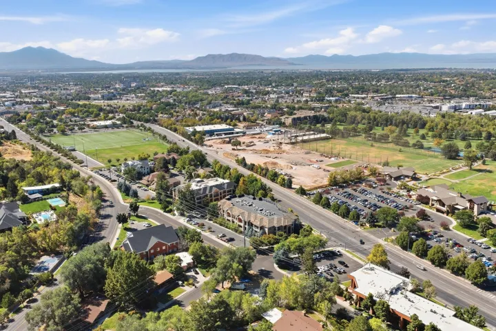 Expansive urban landscape with a distant lake and mountain backdrop