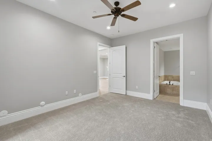Carpeted room with recessed lighting and a ceiling fan