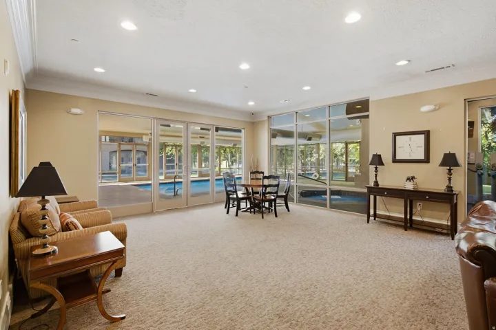 Recessed lighting throughout, crown molding, expansive glass panel doors, and neutral wall tones
