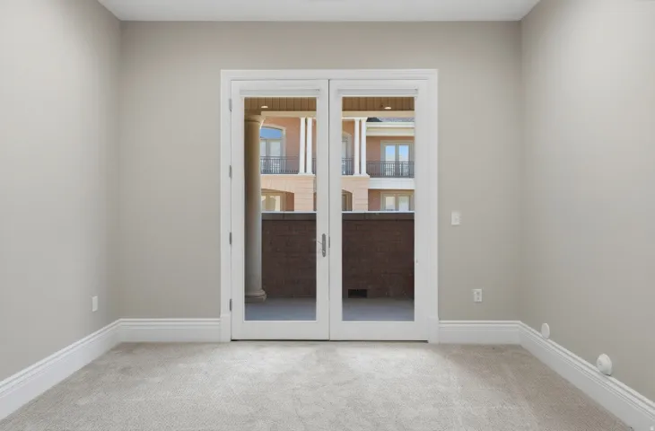 Double French doors leading to a private balcony