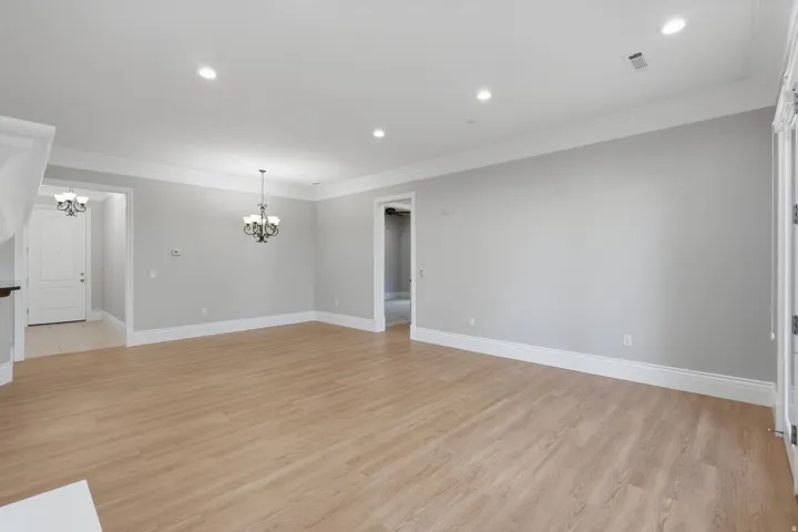 Wood-finish flooring throughout, recessed lighting, and crown molding