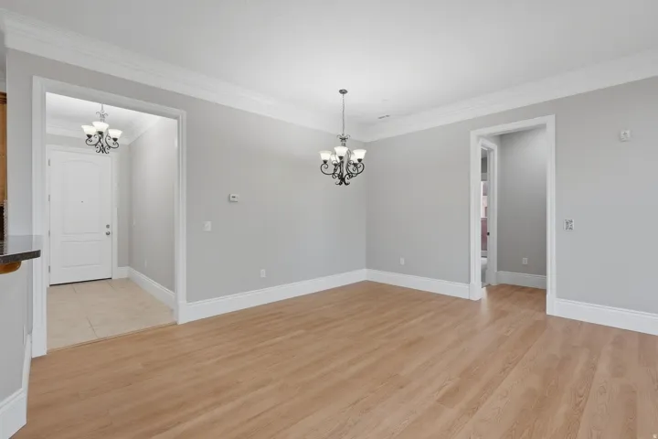 Wood-finish flooring throughout, complemented by crown molding and white baseboards