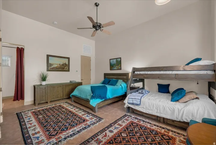 Tiled flooring, vaulted ceiling, ceiling fan, solid wood-finish bunk beds, and a recessed doorway