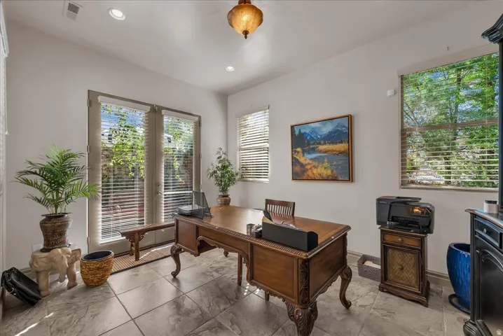 Tile flooring, multiple windows with blinds, recessed lighting, and French doors