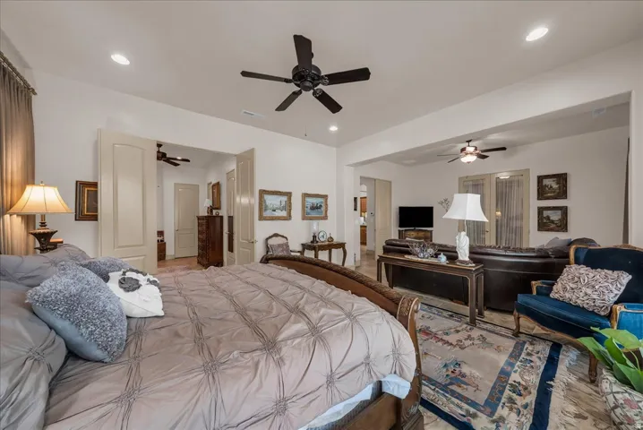 Recessed lighting, ceiling fans, and an arched entryway