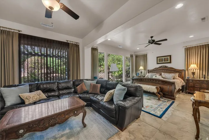 Vaulted ceilings, recessed lighting, and tile flooring