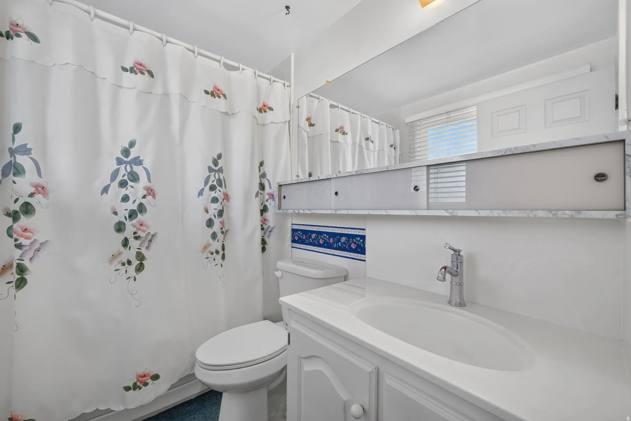 Built-in vanity with integrated sink, chrome faucet, and cabinet storage