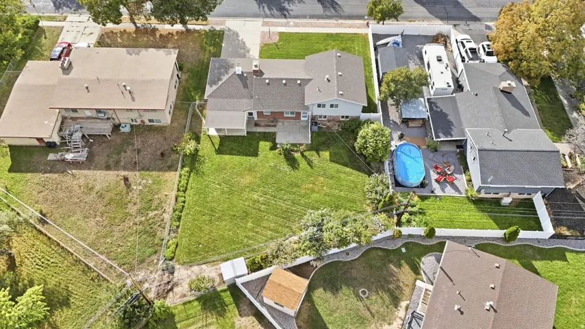 Expansive property featuring a large grassy area, an above-ground pool, and mature trees