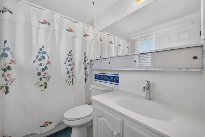 Built-in vanity with integrated sink, chrome faucet, and cabinet storage