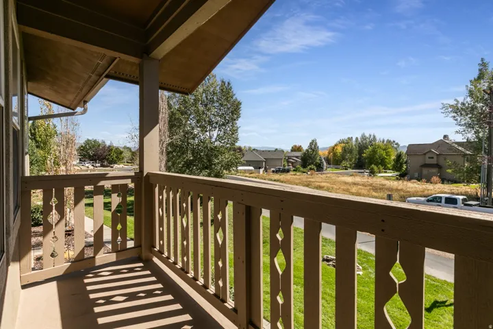 Covered balcony featuring decorative railing