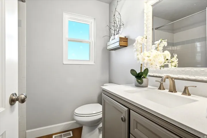 White single-hung window with a light blue sky backdrop