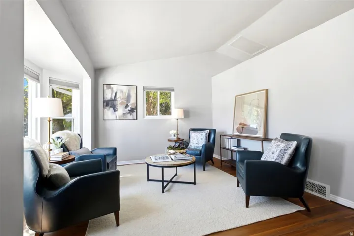Hardwood flooring, bay windows, vaulted ceiling, and recessed lighting
