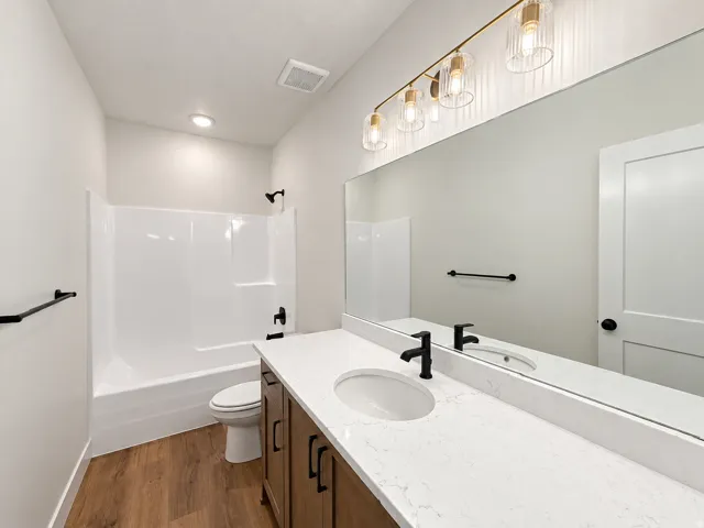 White shower-tub combination with matte black fixtures
