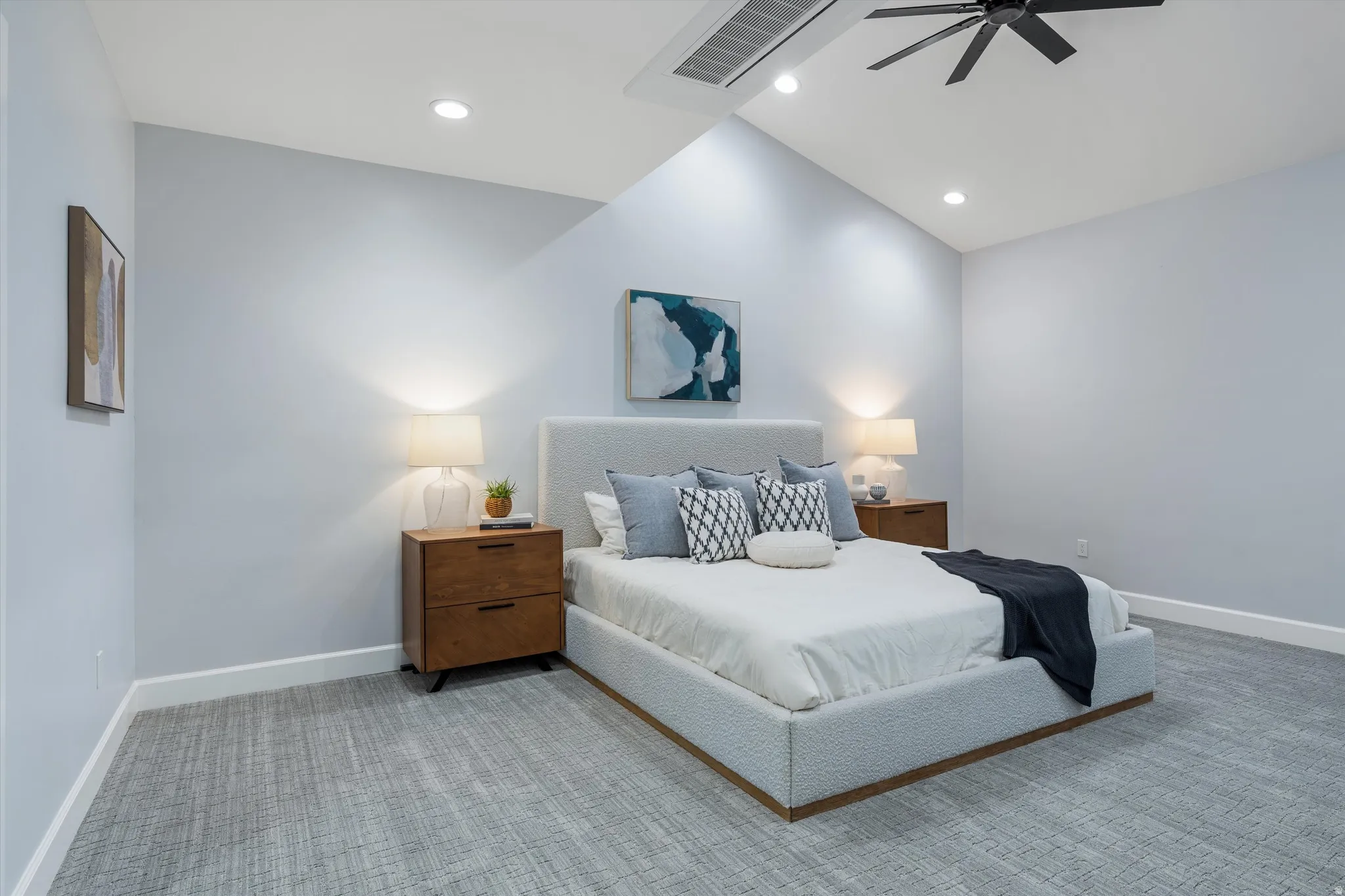 Vaulted ceiling with recessed lighting and a ceiling fan