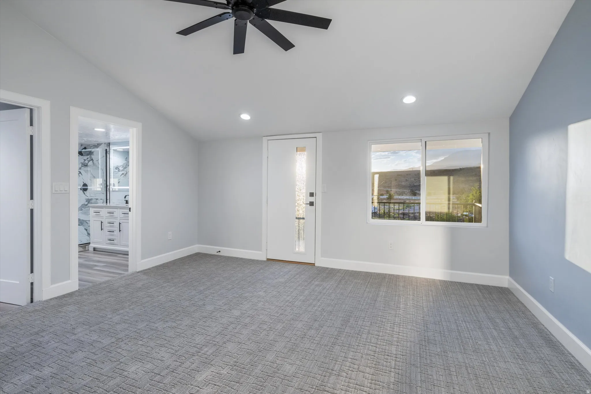 Vaulted ceiling with a black ceiling fan