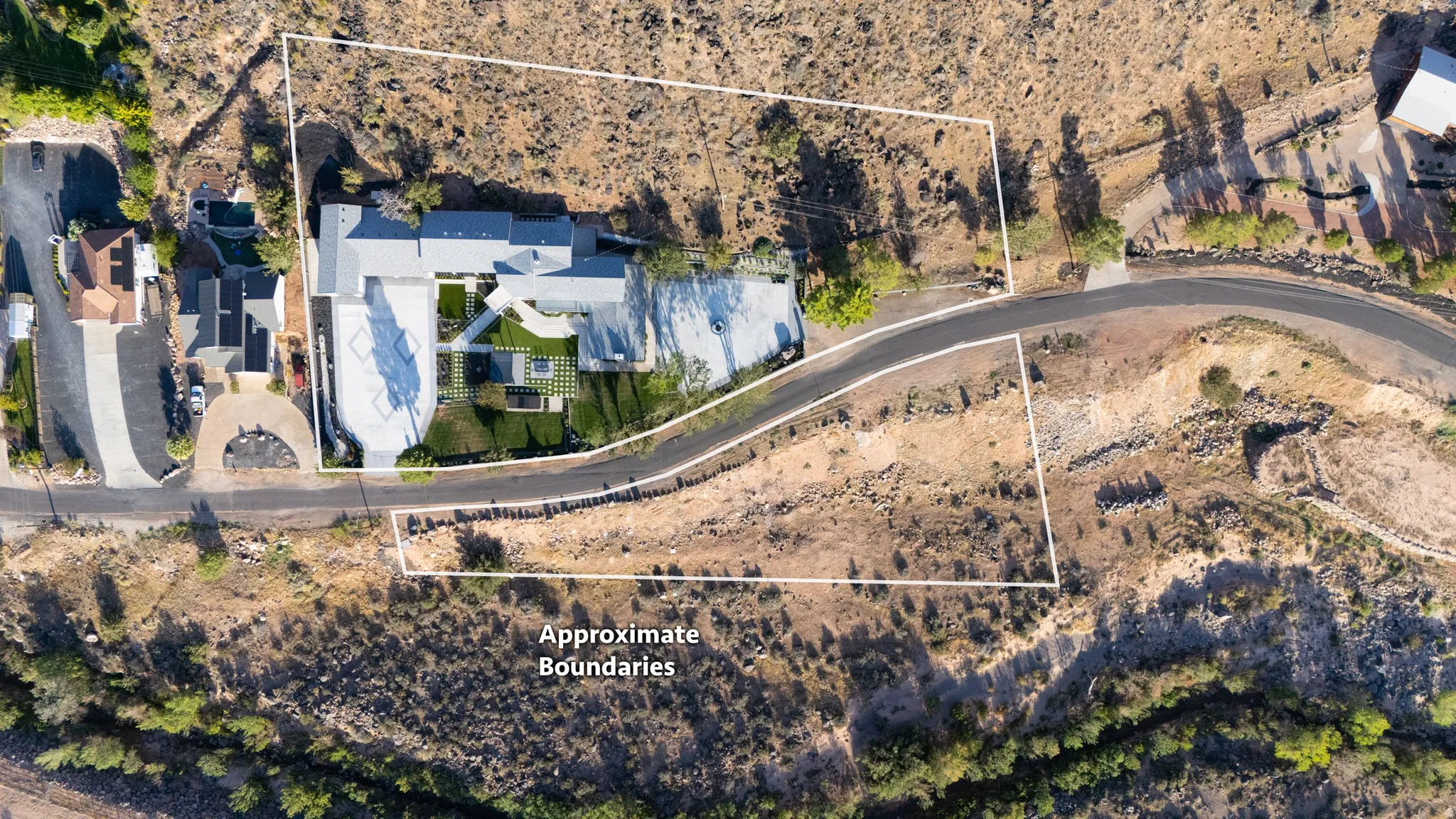 Extensive property with a contemporary-style residence, paved driveways, a landscaped courtyard, and undeveloped land parcels