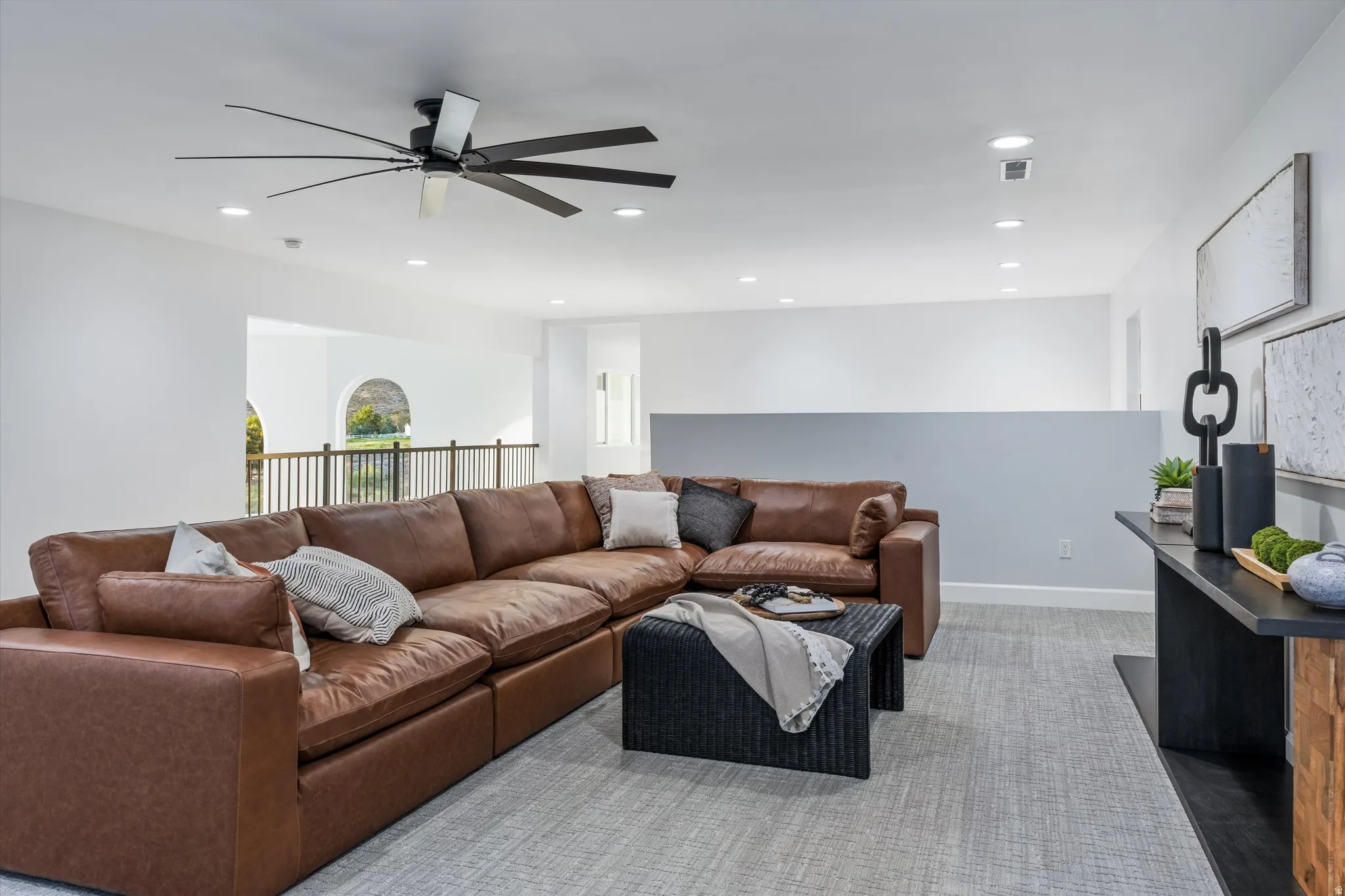 Recessed lighting, ceiling fan, carpet flooring, and a half-wall partition