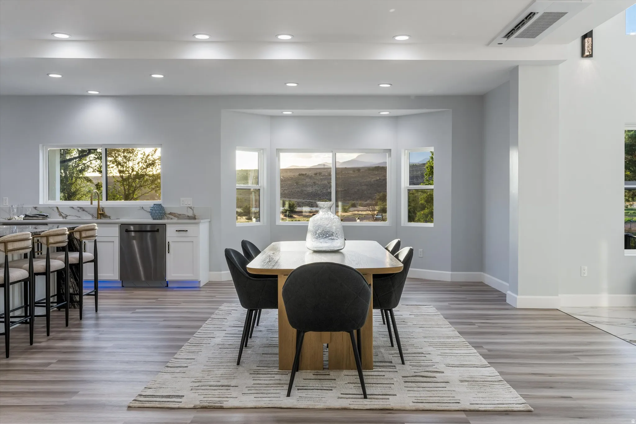 Spacious interior with wood-finish flooring, recessed lighting, and a bay window
