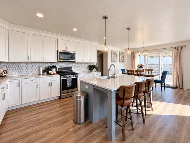 White shaker cabinetry, stainless steel appliances, patterned tile backsplash, wood-finish flooring, and a kitchen island with pendant lighting
