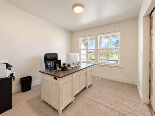 Recessed lighting, light-colored carpeting, white wall paint, and white trim