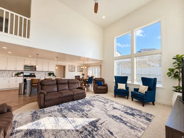 Two-story living area with high ceilings, large windows, and an open concept layout