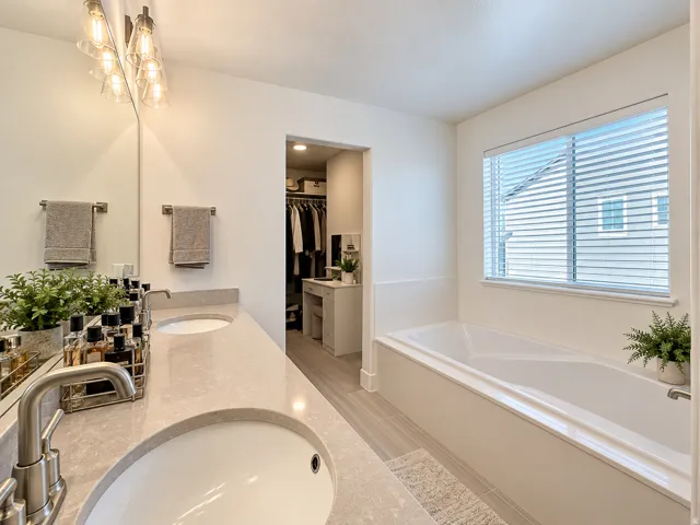 Dual vanity with undermount sinks, stone countertops, and brushed nickel fixtures