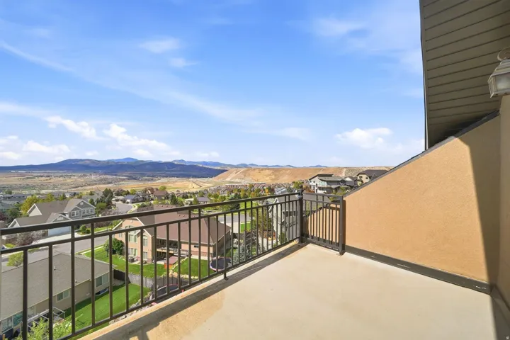 Private balcony with a metal railing and stucco exterior