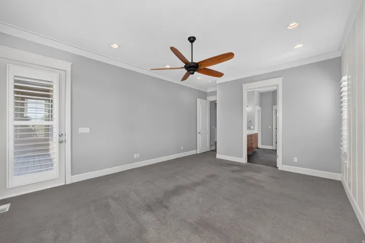 Wood-finish ceiling fan, recessed lighting, and crown molding