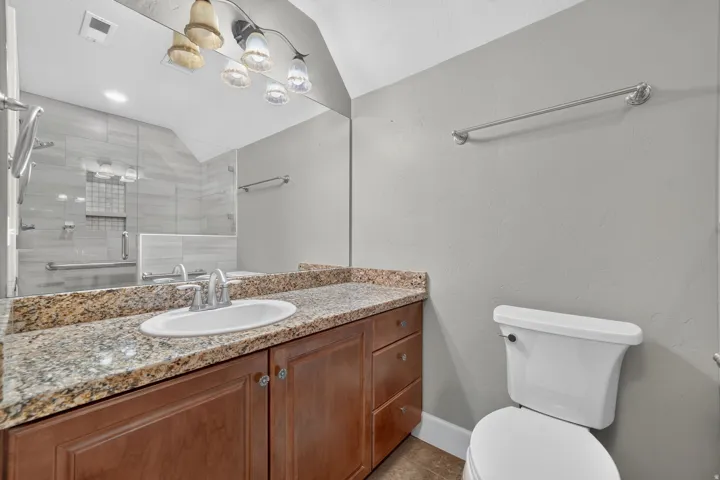 Vanity with a granite-style countertop and an integrated sink