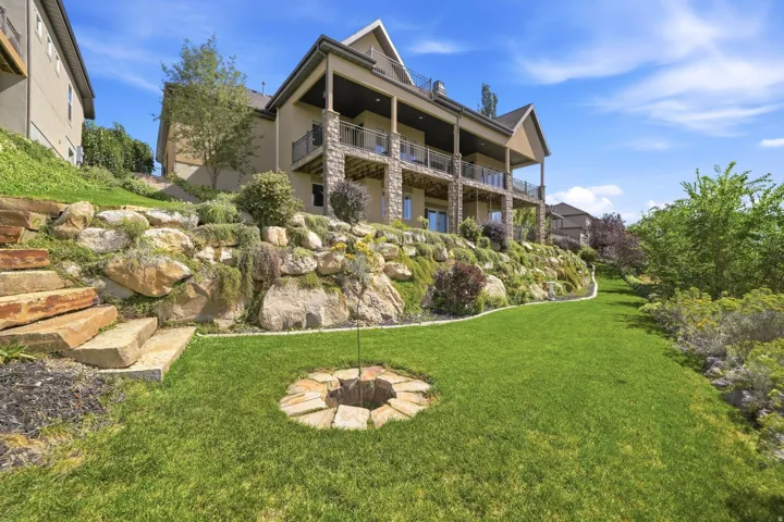 Multi-level exterior with stone veneer accents and covered balconies