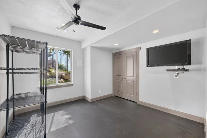 Recessed lighting, ceiling fan, and painted double doors