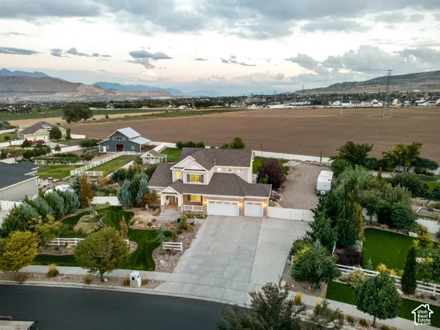 Two-story property with an attached three-car garage and a concrete driveway