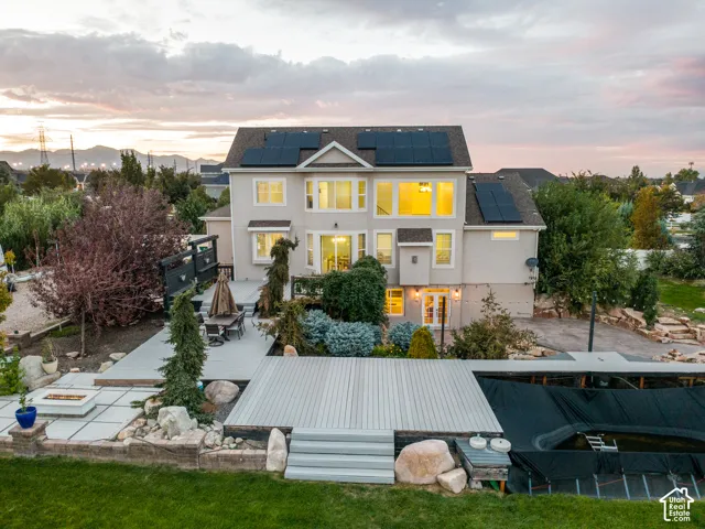 Expansive stucco exterior with multiple solar panel arrays