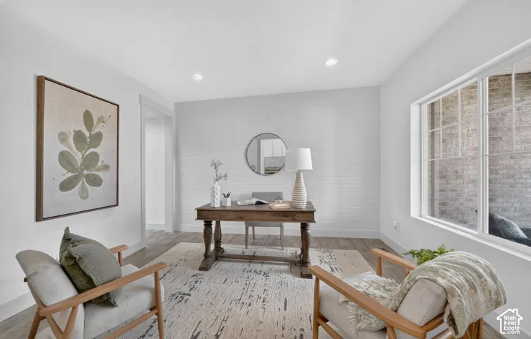 Bright interior space featuring wood-finish flooring, recessed lighting, and a prominent window