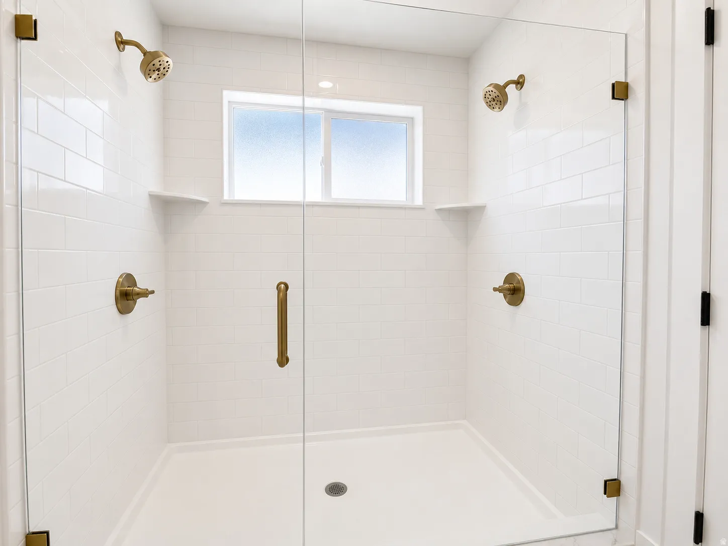 Walk-in shower with dual shower heads and a glass enclosure