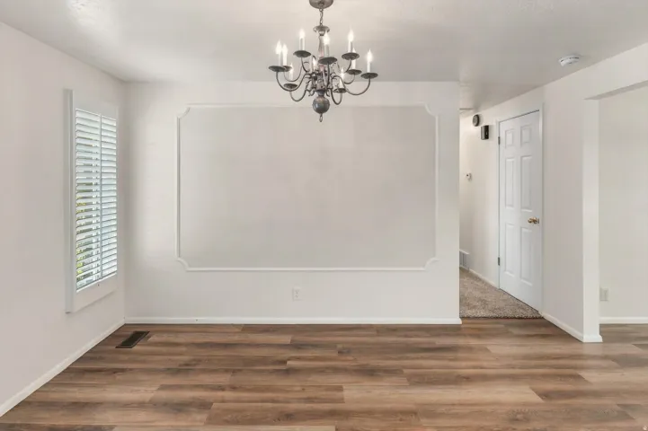 Wood-finish flooring throughout, complemented by a decorative wall molding accent
