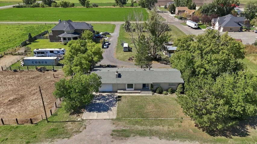 Single-story residence featuring a gray roof, an attached garage, and a concrete driveway