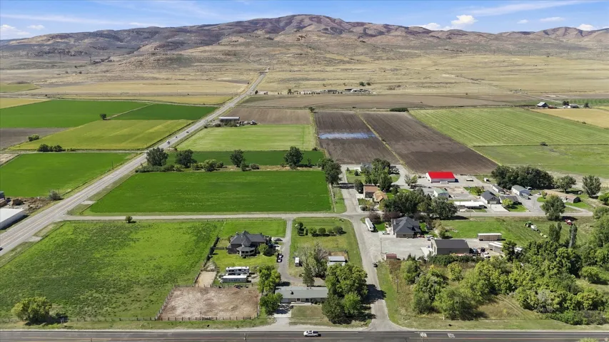 Expansive agricultural land featuring cultivated fields and scattered buildings