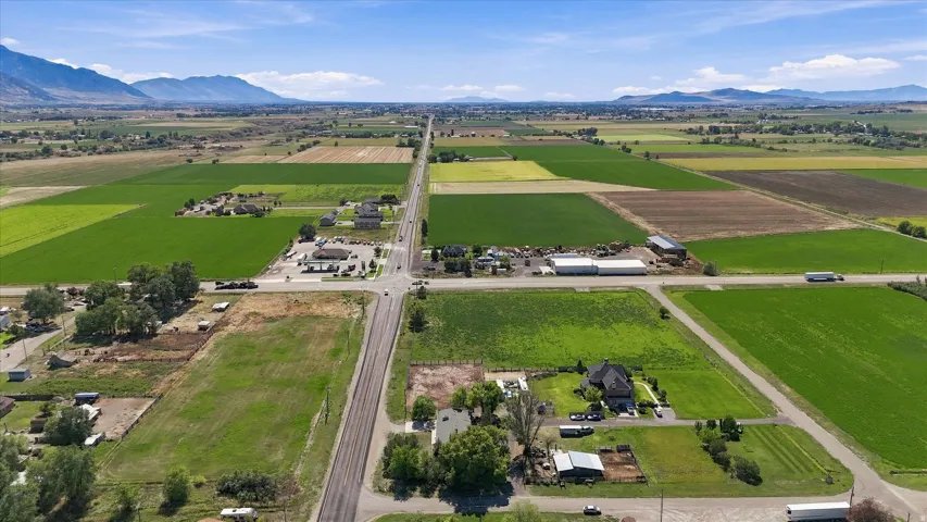Expansive agricultural fields with distant mountain ranges under a clear sky