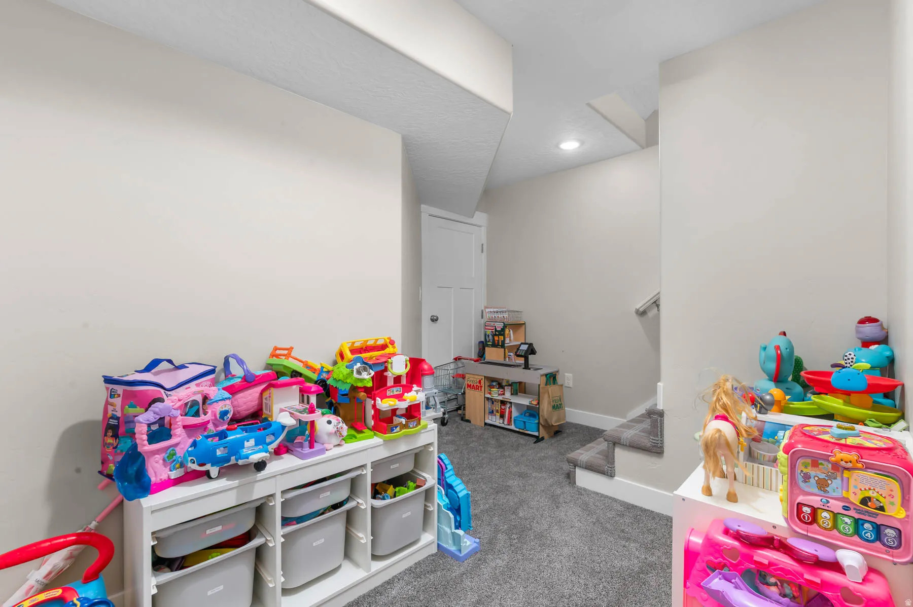 Carpeted flooring, staircase with handrail, recessed lighting, and painted walls