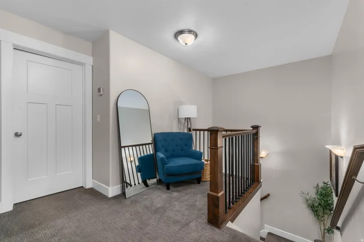 Hardwood newel posts, wrought iron balusters, and wall-mounted sconces