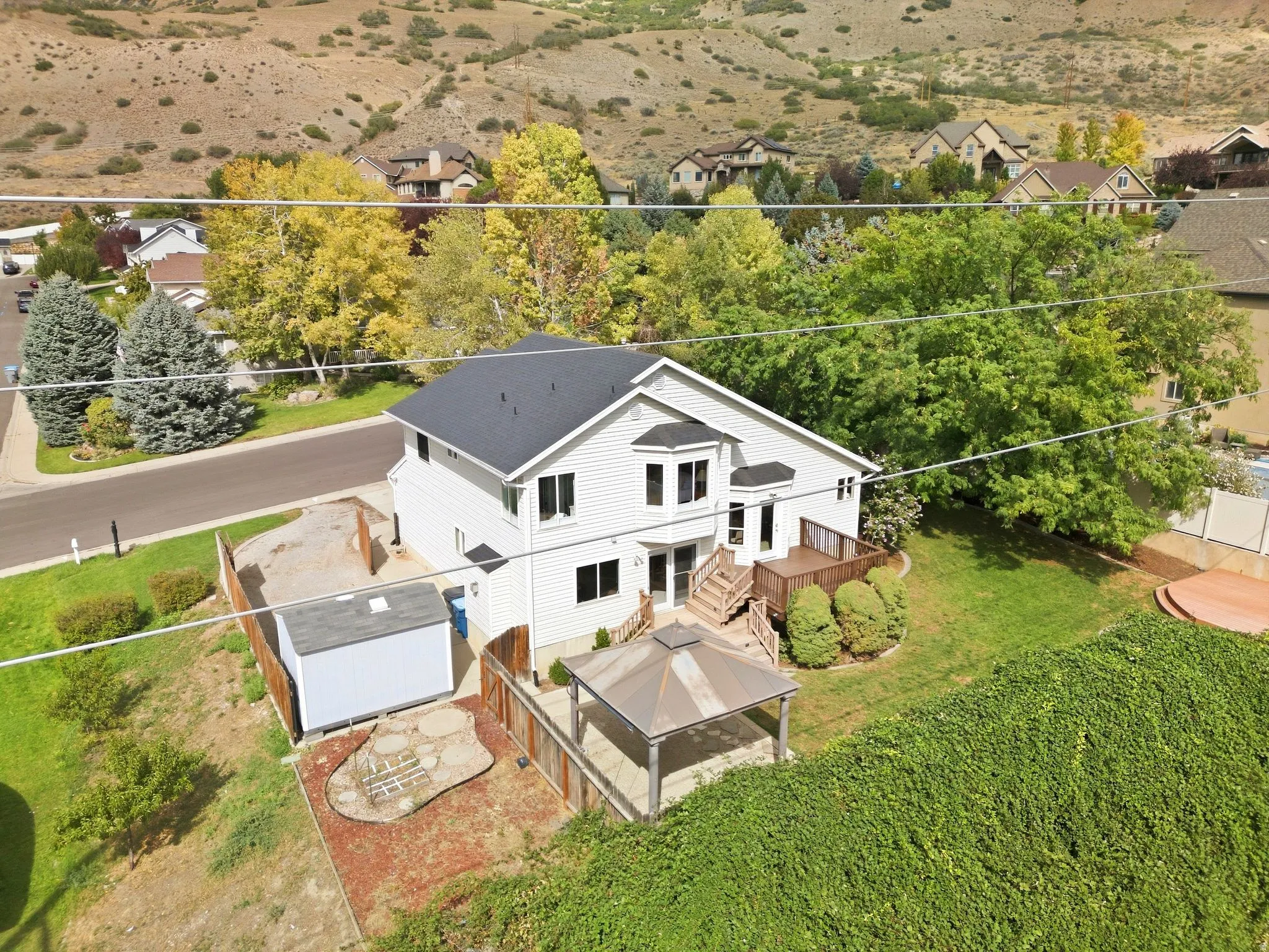 Back exterior view of the home and the yard