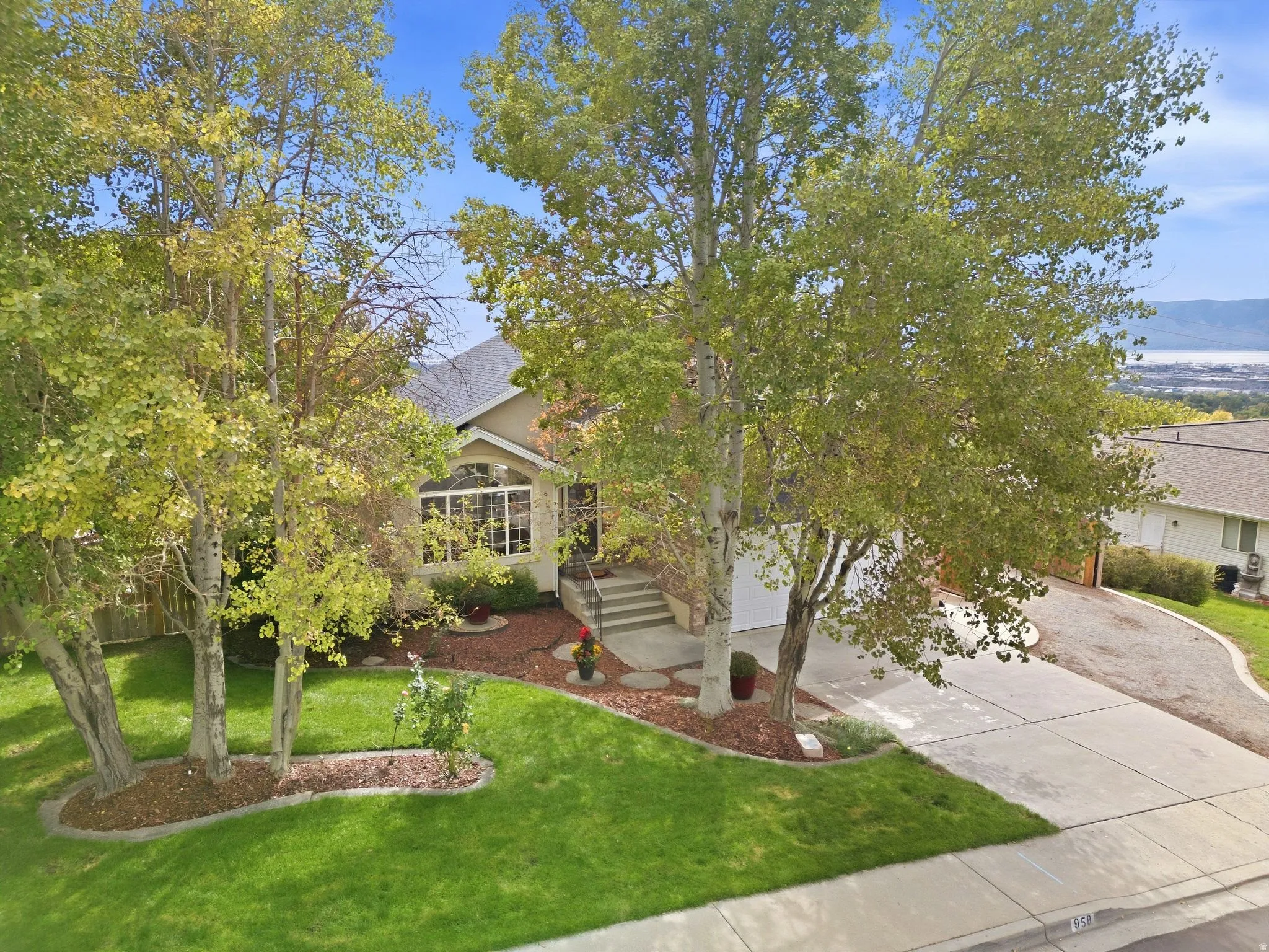 Manicured lawn with mature trees, established landscaping, and ample privacy