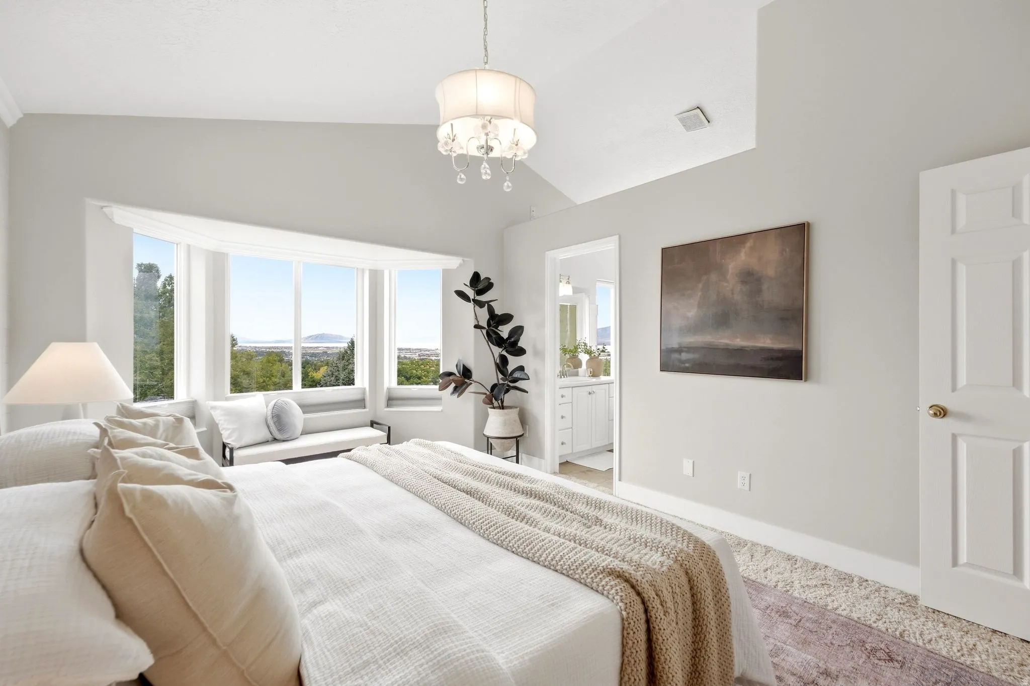 Primary bedroom with vaulted ceilings, full natural light, and spectacular mountain, lake, and valley views