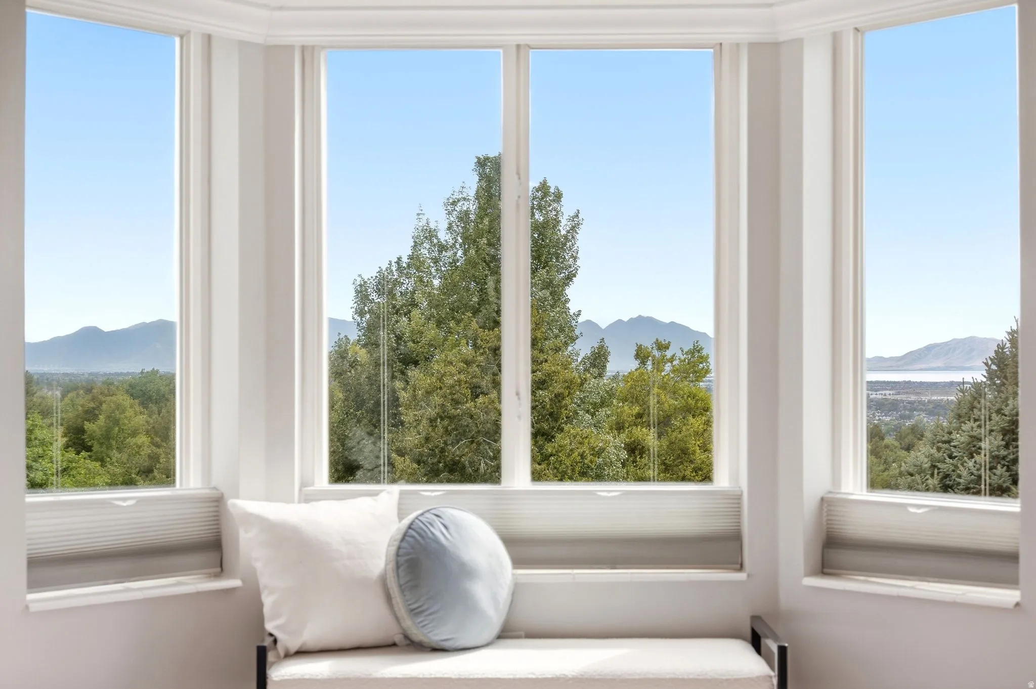 View from the bay window in the primary bedroom with incredible mountain and lake views.