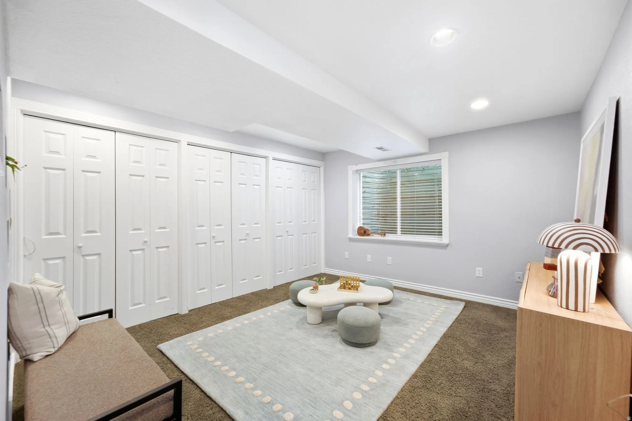 Basement living room with fresh paint, tons of storage, and full egress windows