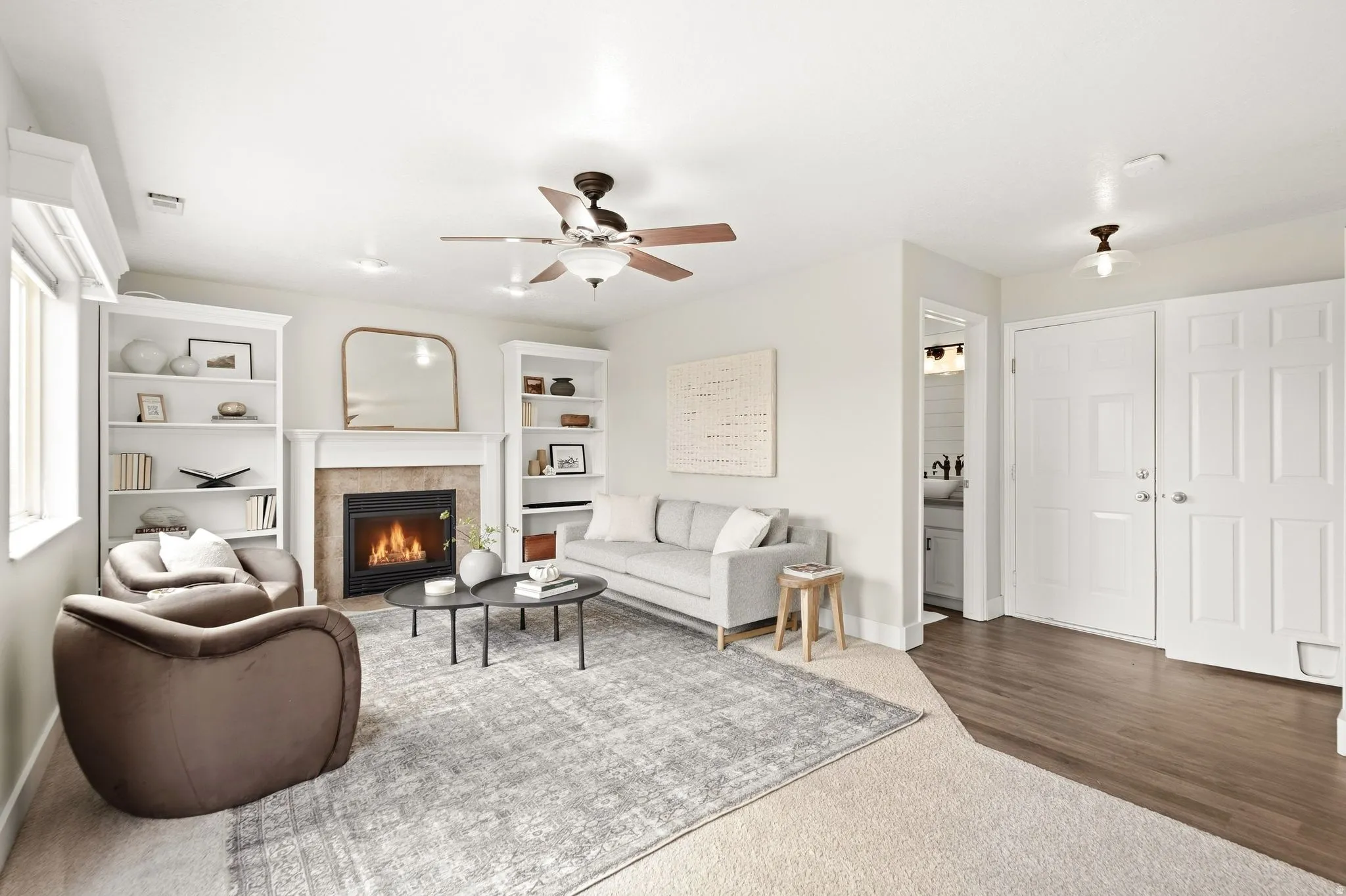 Lower living room with a view of the garage entrance as well as the half-bath entrance